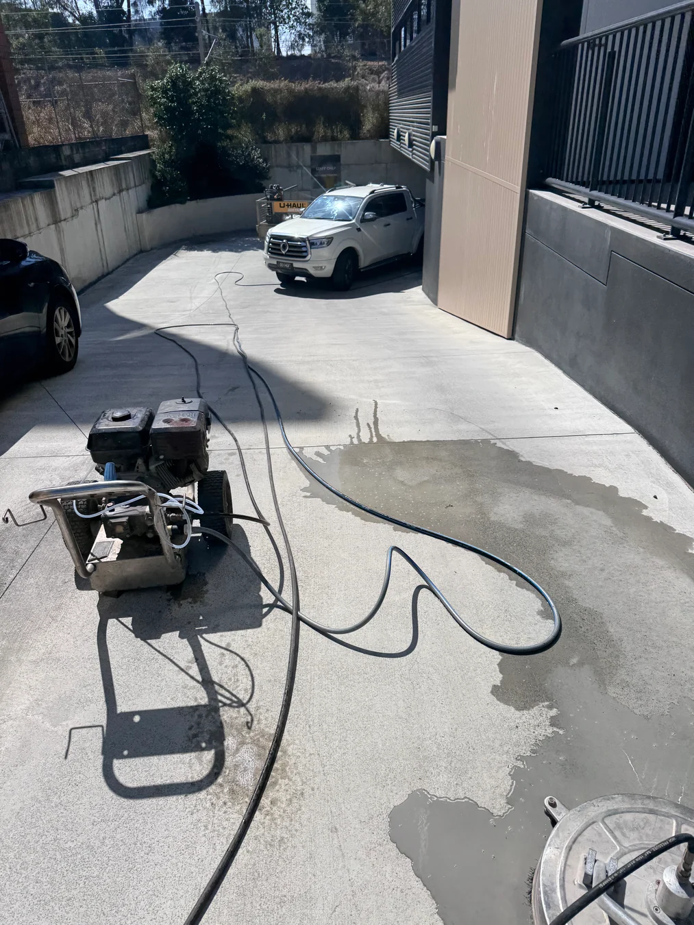 Professional surface-cleaning equipment on a Brisbane concrete driveway